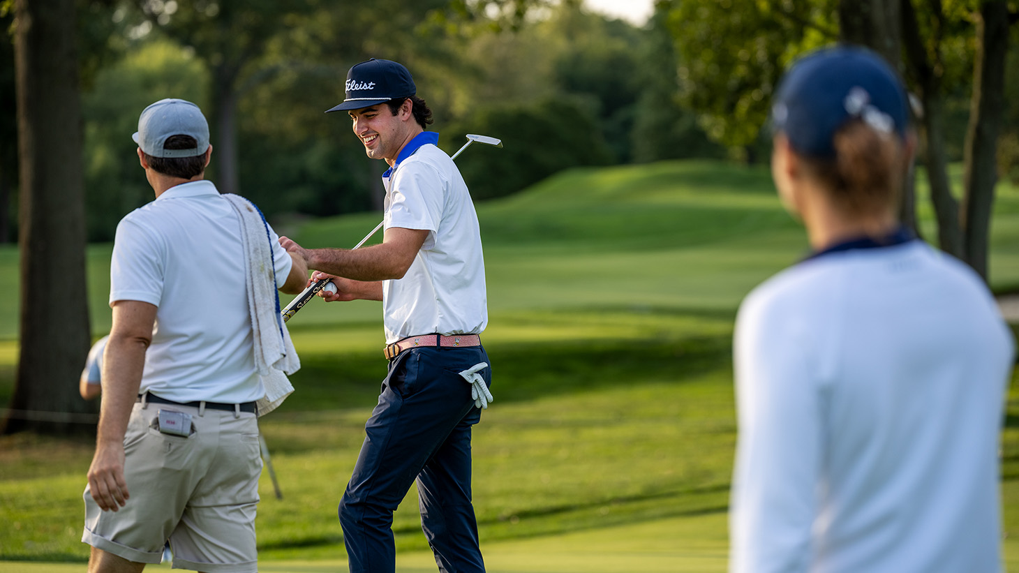 Tim gets a fist-bump from his caddie after...