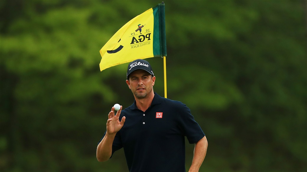 Adam Scott Raises his Pro V1 golf ball to slaute the crowd at Bethpage Black after holing a biride putt during action at the 2019 PGA Championship